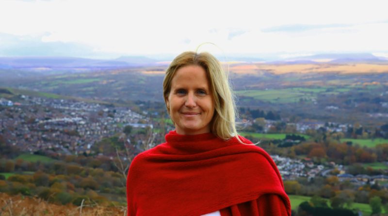 Photo of Beth Winter with view of Cynon Valley in background