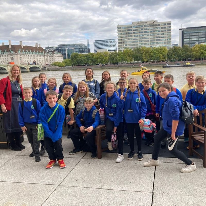 Photo of me with children from Penywaun primary school in Westminster, in front of the Thames!